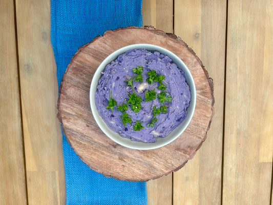 A vibrant bowl of ʻUlu ʻUala Mash, garnished with fresh parsley 